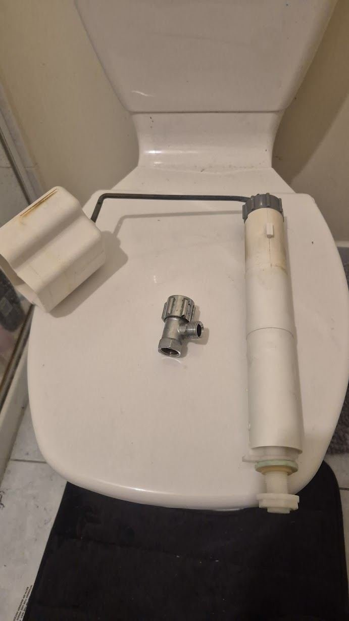 Cistern inlet valve and outlet parts replaced during a toilet repair